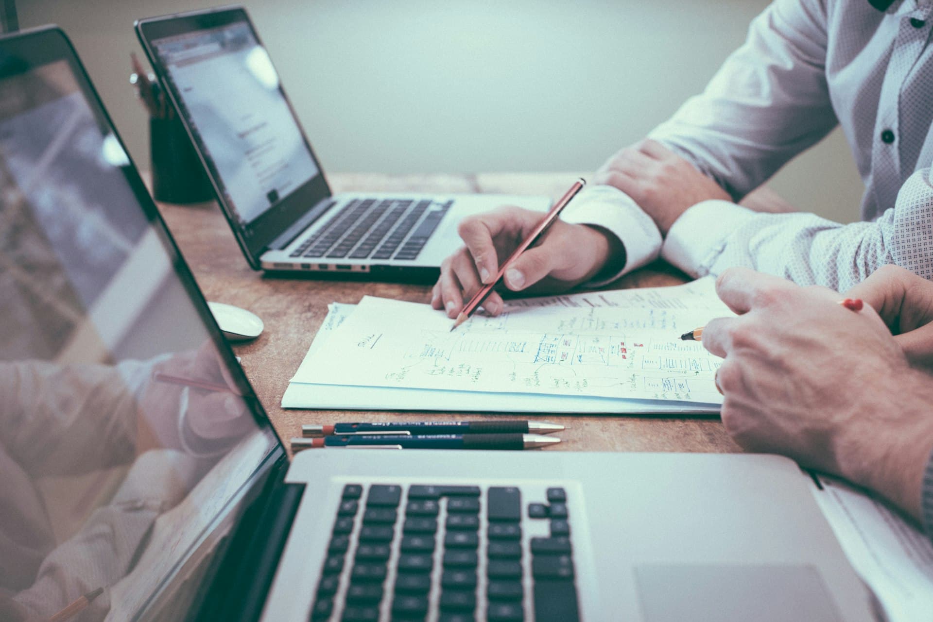 Financial planning notes and a laptop on a desk